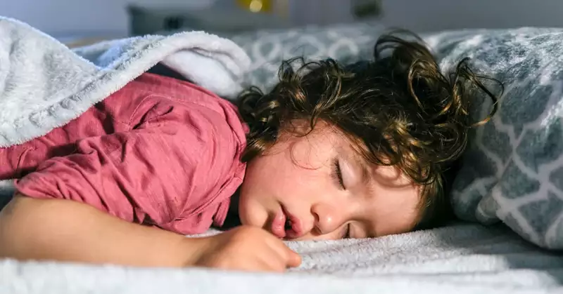Child sleeping in a bed